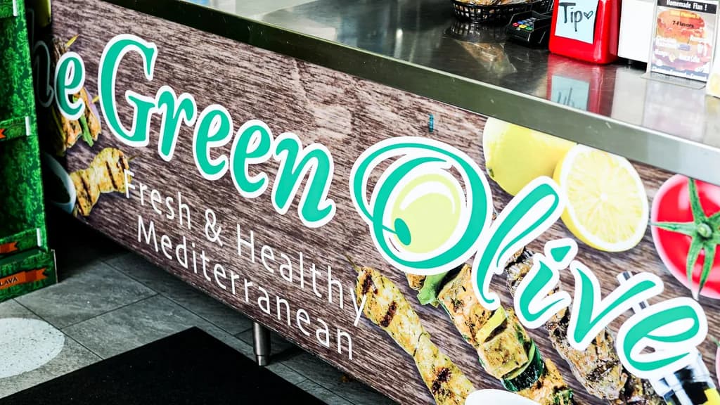 The Green Olive Fresh & Healthy Mediterranean sign on the front counter