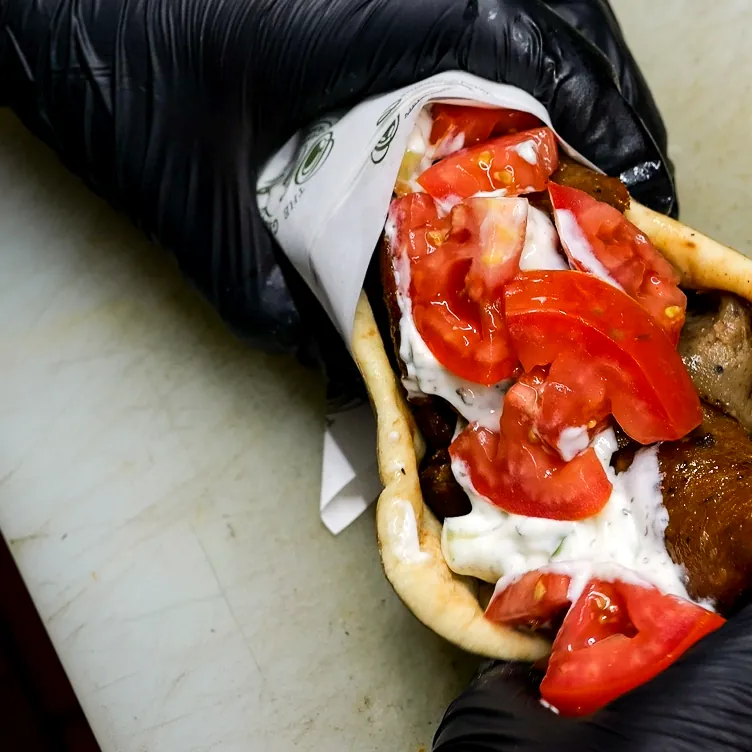 Gyro wrap with tomato and tzatziki in warm flatbread